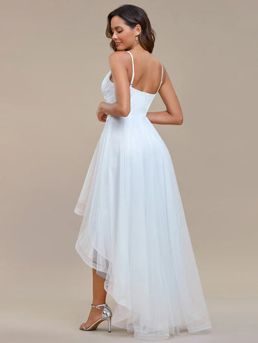 Modern high-low white wedding dress with mesh overlay and floral appliqués