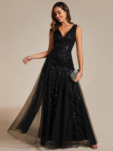 Black sleeveless evening dress with shiny sequins, deep V-neckline, and tulle skirt