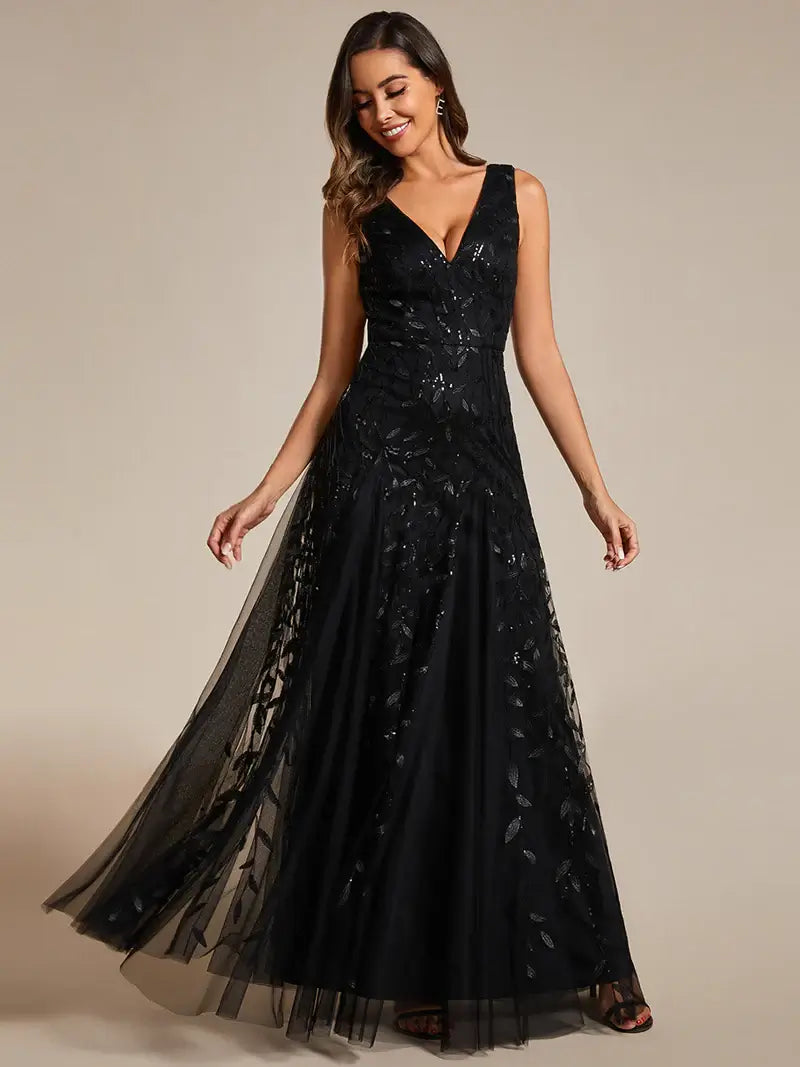 Black sleeveless evening dress with shiny sequins, deep V-neckline, and tulle skirt