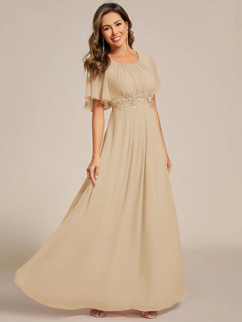 charcoal a-line floor-length evening dress with short sleeves, pleated skirt, and applique embellishments