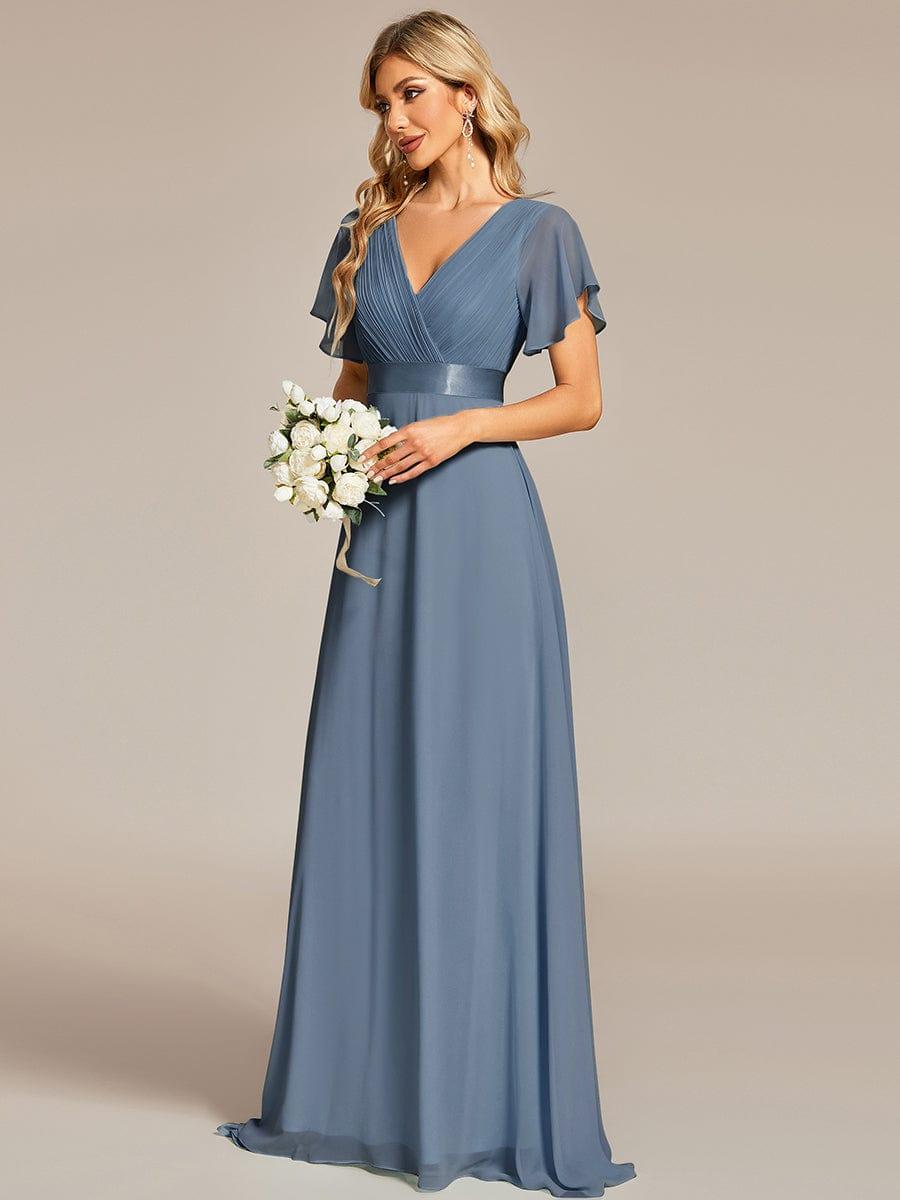Dusty blue glamorous evening gown with double V-neckline, ruffle detailing, and padded bodice