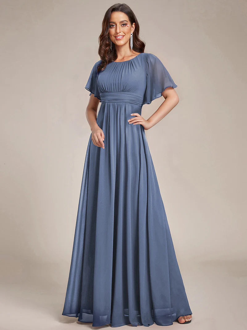 Round neck dusty blue bridesmaid gown in a pleated design for elegant wedding looks