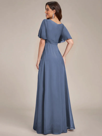 Round neck dusty blue bridesmaid gown in a pleated design for elegant wedding looks