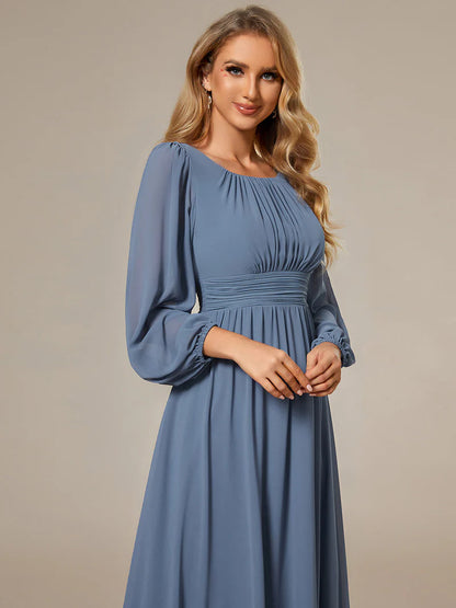 Dusty blue bridesmaid dress with round neckline and long lantern sleeves