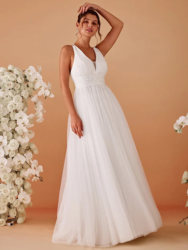 Elegant white mesh wedding dress with V-neckline, floral appliqués, and open back