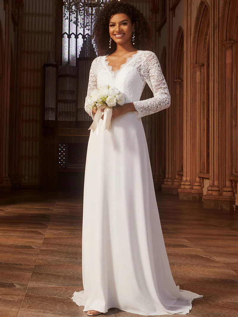 Woman in a white wedding dress holding flowers in an elegant indoor setting