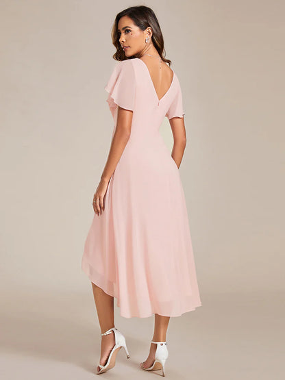 Elegant chiffon wedding guest pink dress with pleated skirt and ruffle accents