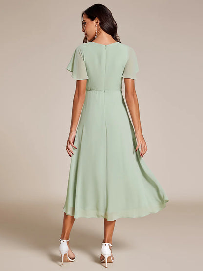 Elegant midi chiffon mint green dress with V-neck and ruffle sleeves, perfect for wedding guests