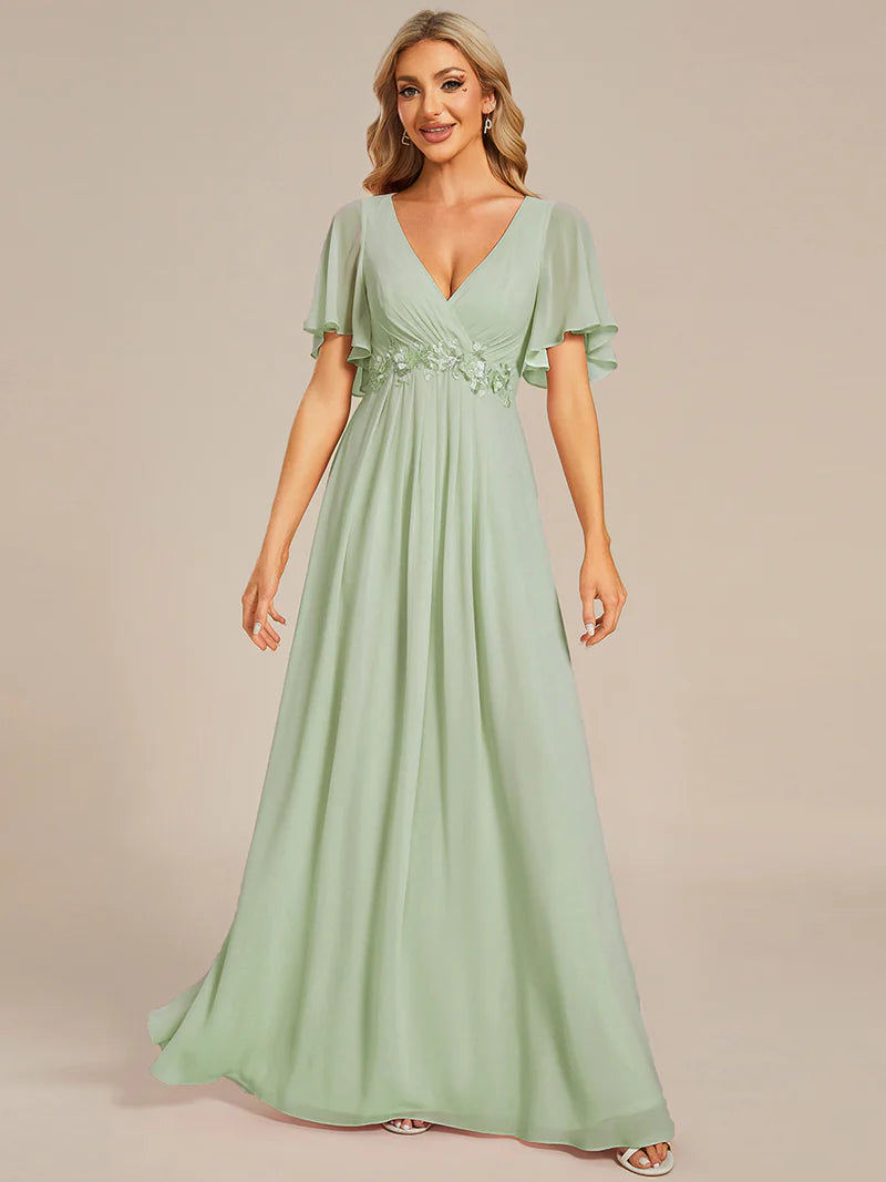 Elegant pleated bridesmaid mint green dress with V-neckline and floral appliqués