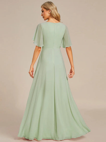 Elegant pleated bridesmaid mint green dress with V-neckline and floral appliqués