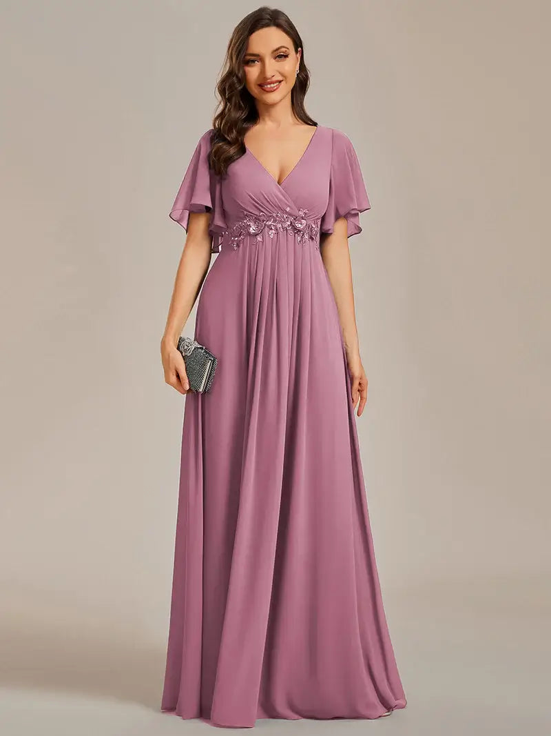 Elegant pleated bridesmaid orhidea dress with V-neckline and floral appliqués