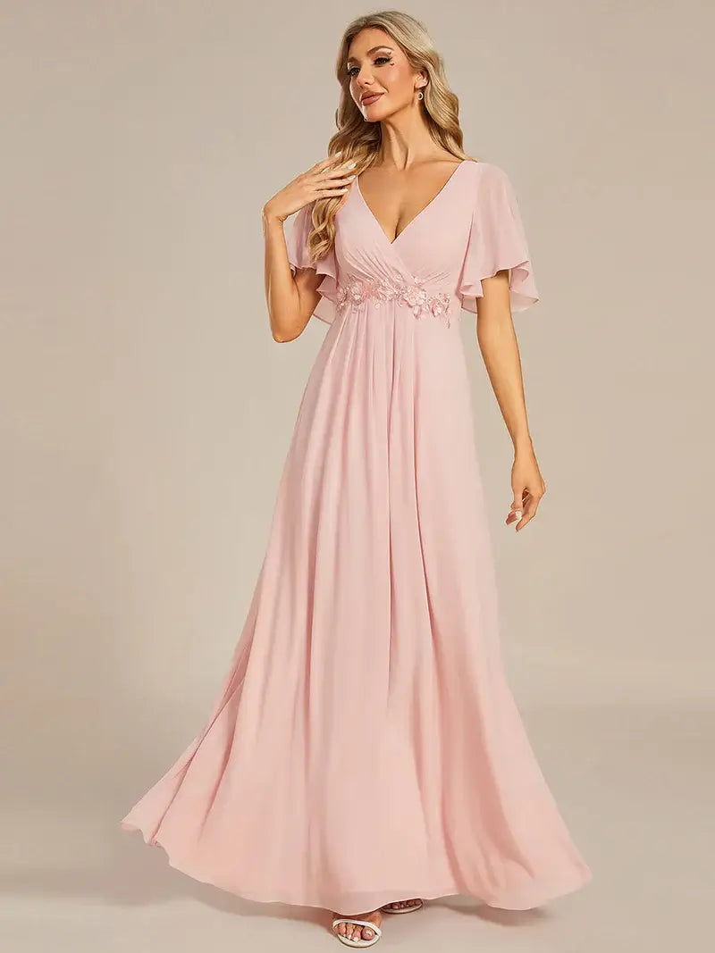 Elegant pleated bridesmaid pink dress with V-neckline and floral appliqués
