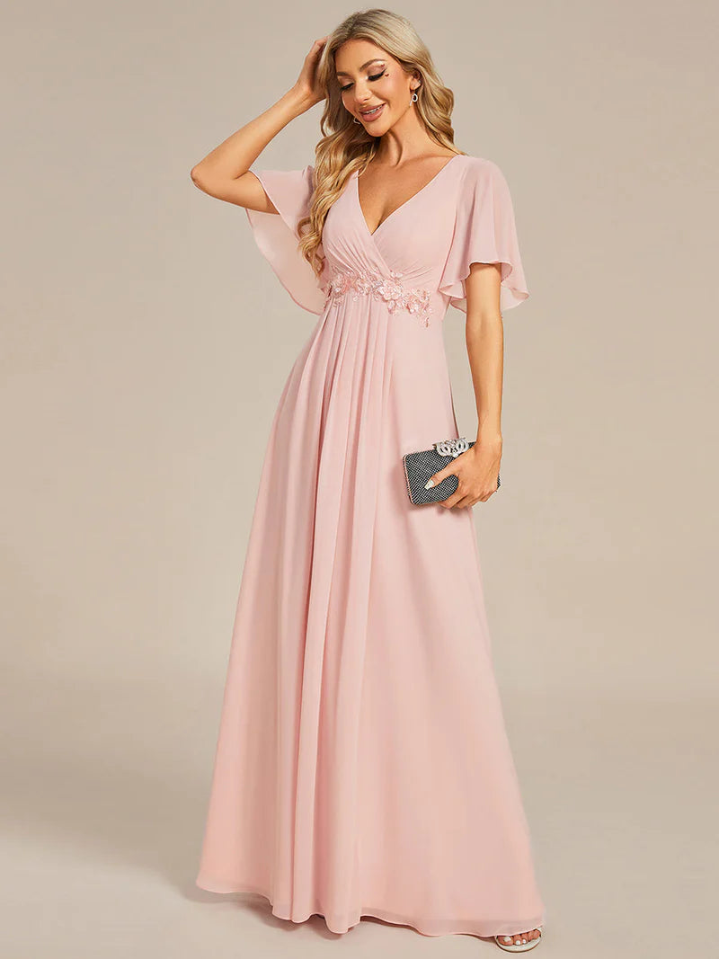 Elegant pleated bridesmaid pink dress with V-neckline and floral appliqués