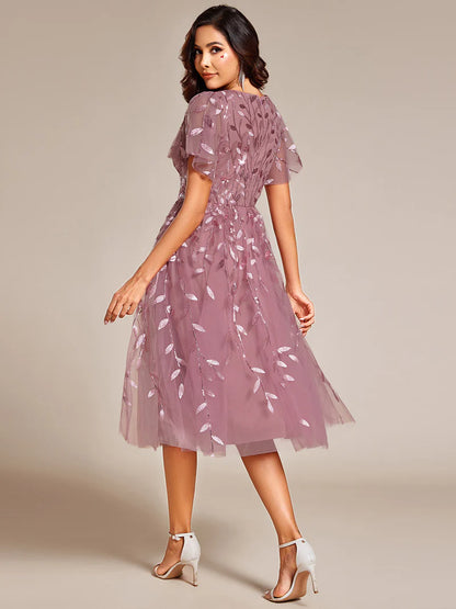 Exquisite midi length Orhidea dress with ruffled sleeves, tulle fabric, sequin details, and embroidery