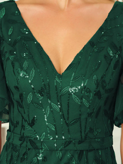 Green V-neck fishtail party dress with shimmering leaf sequin embellishment.