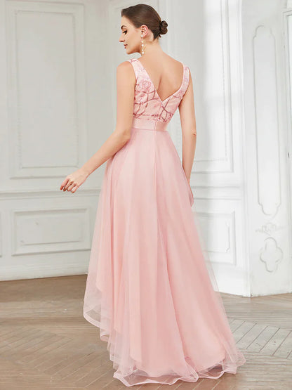 High-low pink tulle prom dress with V-neck and sequin appliques, perfect for formal events