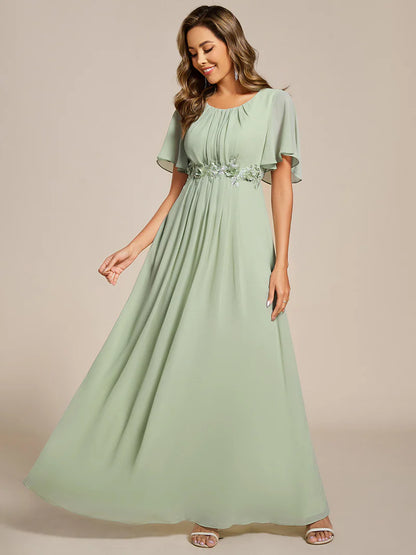 Mint green a-line floor-length evening dress with short sleeves, pleated skirt, and applique embellishments