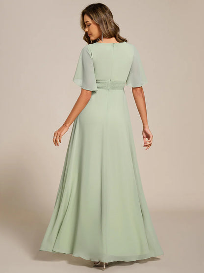 Mint green a-line floor-length evening dress with short sleeves, pleated skirt, and applique embellishments