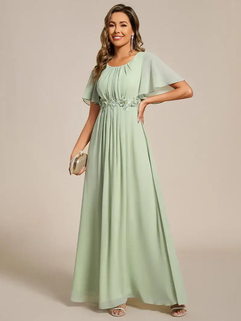 Mint green a-line floor-length evening dress with short sleeves, pleated skirt, and applique embellishments