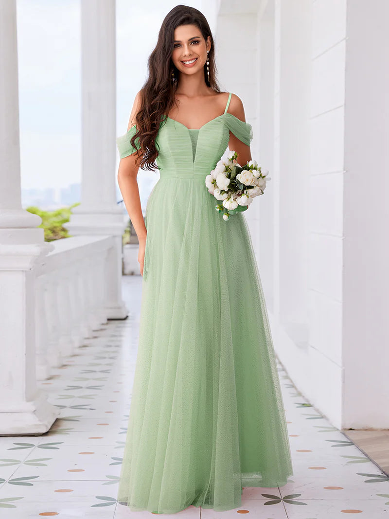 Mint green formal dress with tulle pleats, thin straps, and a romantic sweetheart bodice