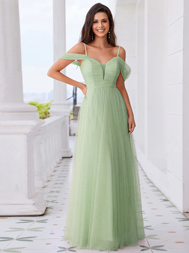 Mint green formal dress with tulle pleats, thin straps, and a romantic sweetheart bodice