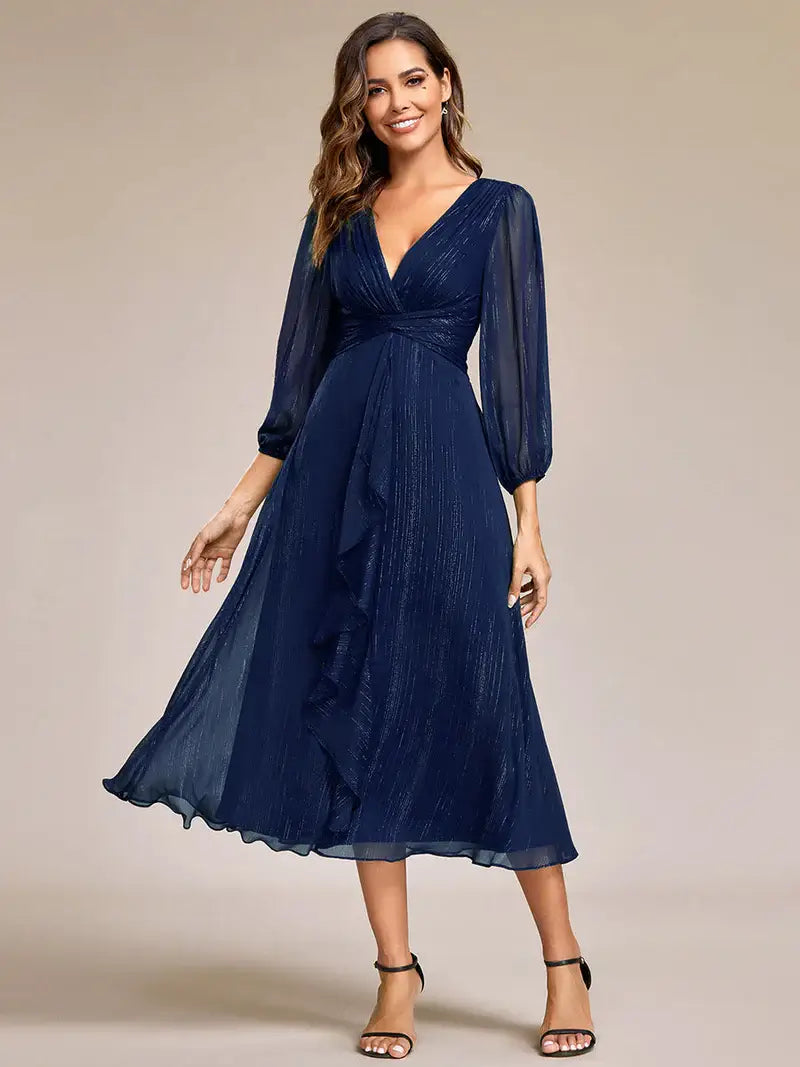 Navy blue elegant shiny chiffon wedding guest dress with long sleeves and flowing silhouette
