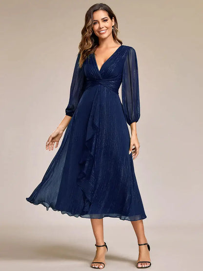 Navy blue elegant shiny chiffon wedding guest dress with long sleeves and flowing silhouette