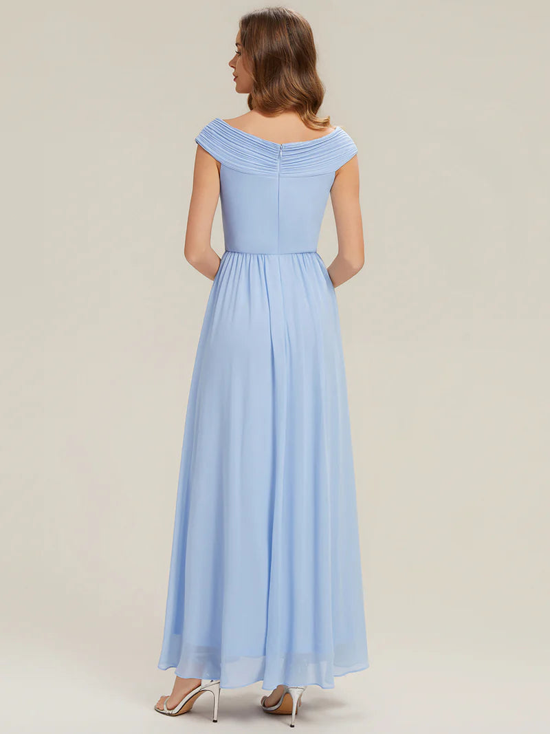 Woman wearing a sky blue off-shoulder dress against a plain background