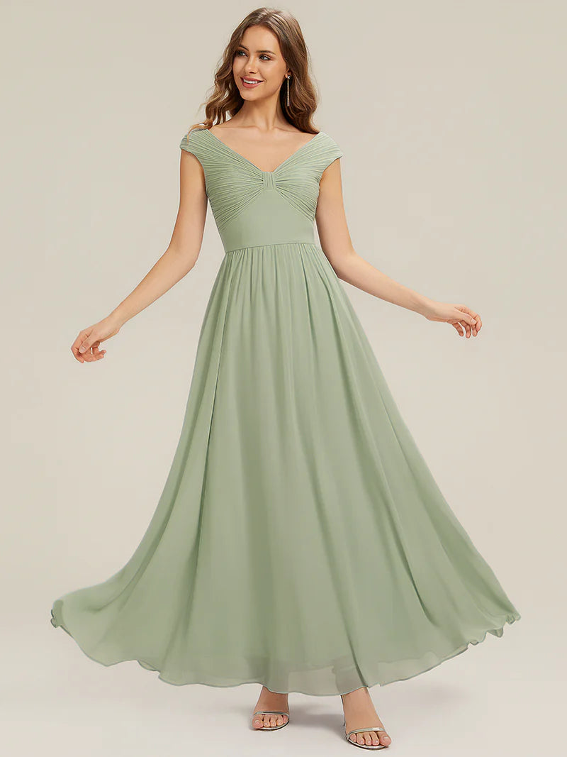 Woman wearing a mint green dress on a plain background