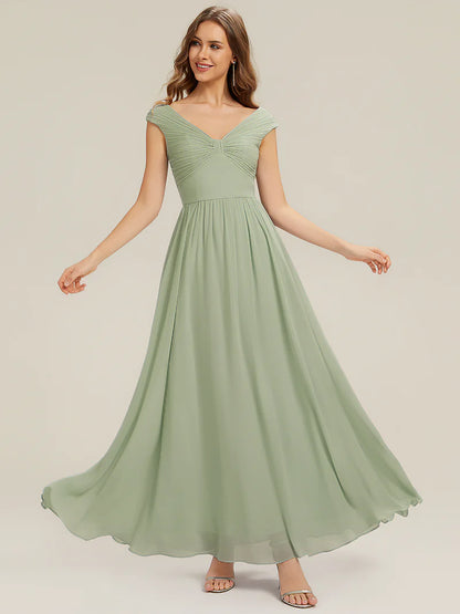 Woman wearing a mint green dress on a plain background