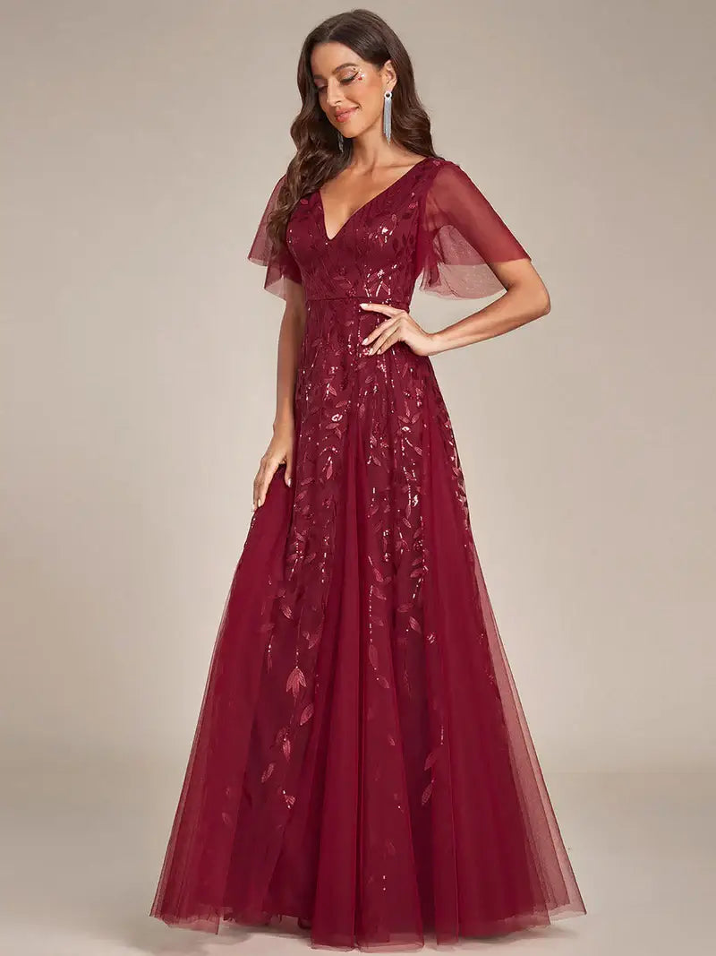 Romantic shimmery evening gown with V-neckline, ruffle sleeves, and floor-length maxi silhouette burgundy dress