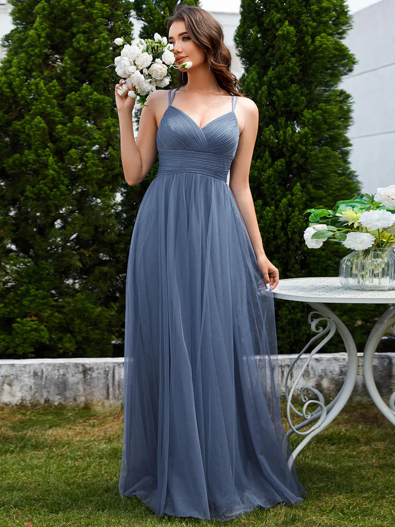 Romantic tulle dusty blue bridesmaid dress with spaghetti straps, lace halter neckline, and open back