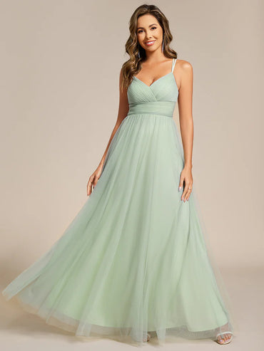 Romantic mint green blue bridesmaid dress with spaghetti straps, lace halter neckline, and open back