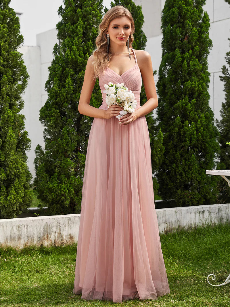 Romantic pink bridesmaid dress with spaghetti straps, lace halter neckline, and open back