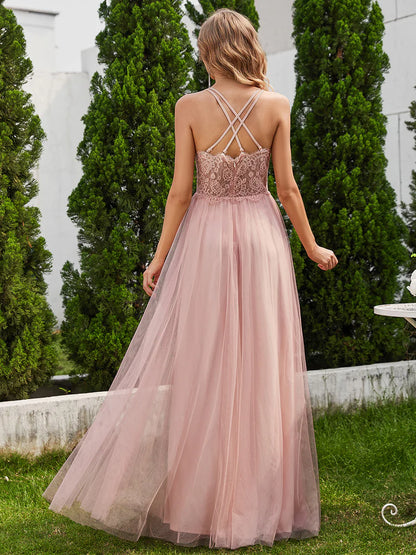Romantic pink bridesmaid dress with spaghetti straps, lace halter neckline, and open back