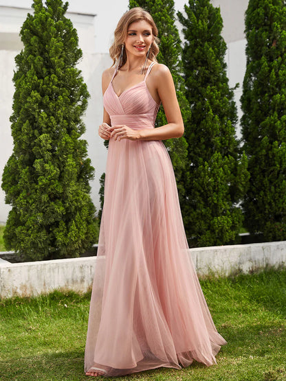 Romantic pink bridesmaid dress with spaghetti straps, lace halter neckline, and open back