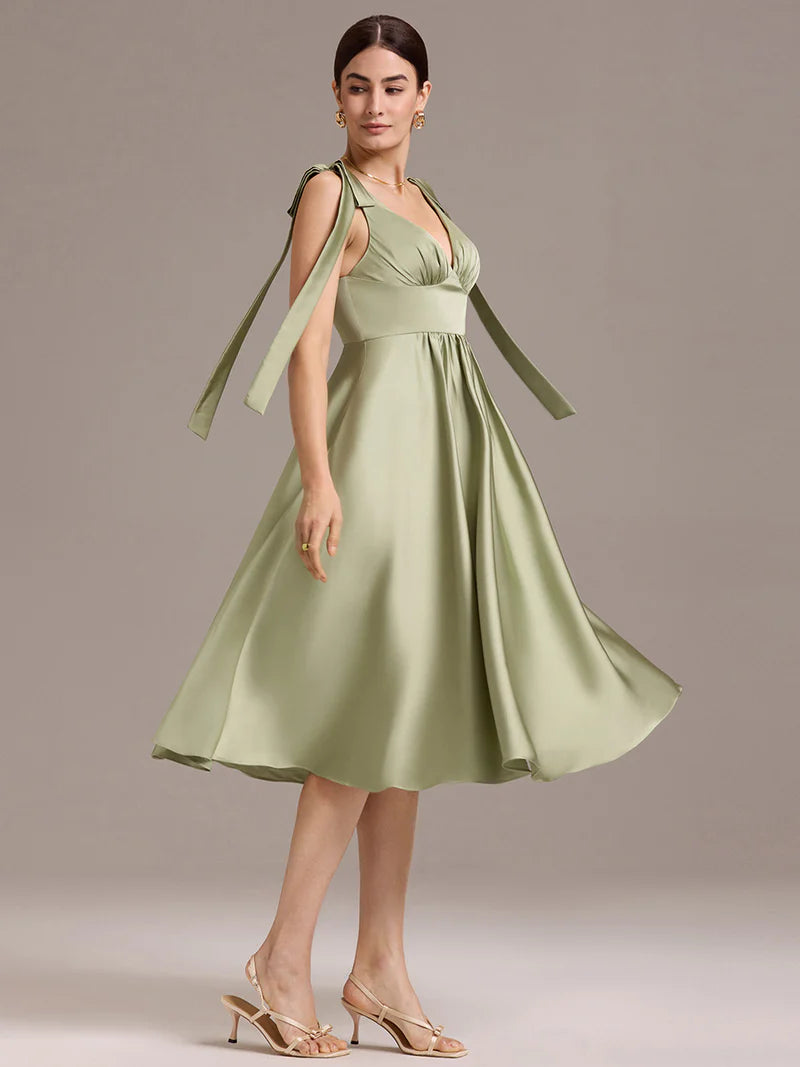 Sage green satin midi dress with V-neckline, tie-shoulder straps, and sleeveless style