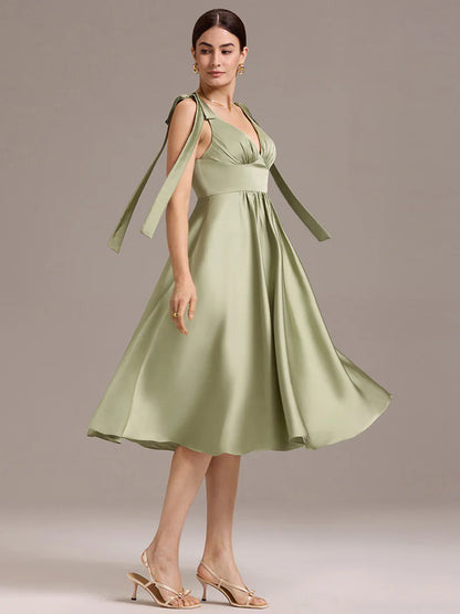 Sage green satin midi dress with V-neckline, tie-shoulder straps, and sleeveless style