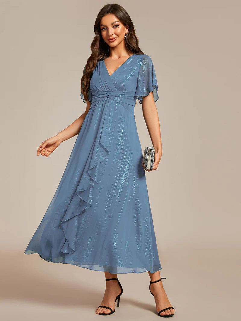 Shimmering V-neck tea length dusty blue dress with short sleeves, perfect for wedding guests