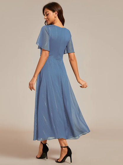 Shimmering V-neck tea length dusty blue dress with short sleeves, perfect for wedding guests