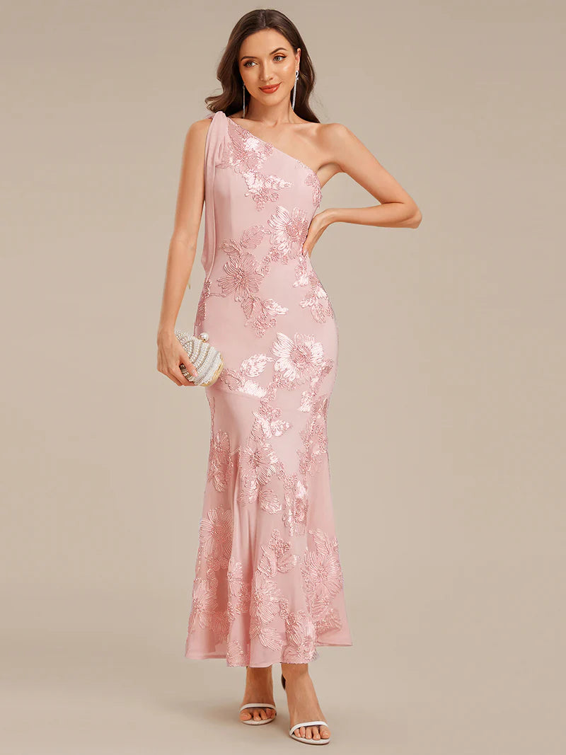 Woman wearing a pink sequin dress on a beige background