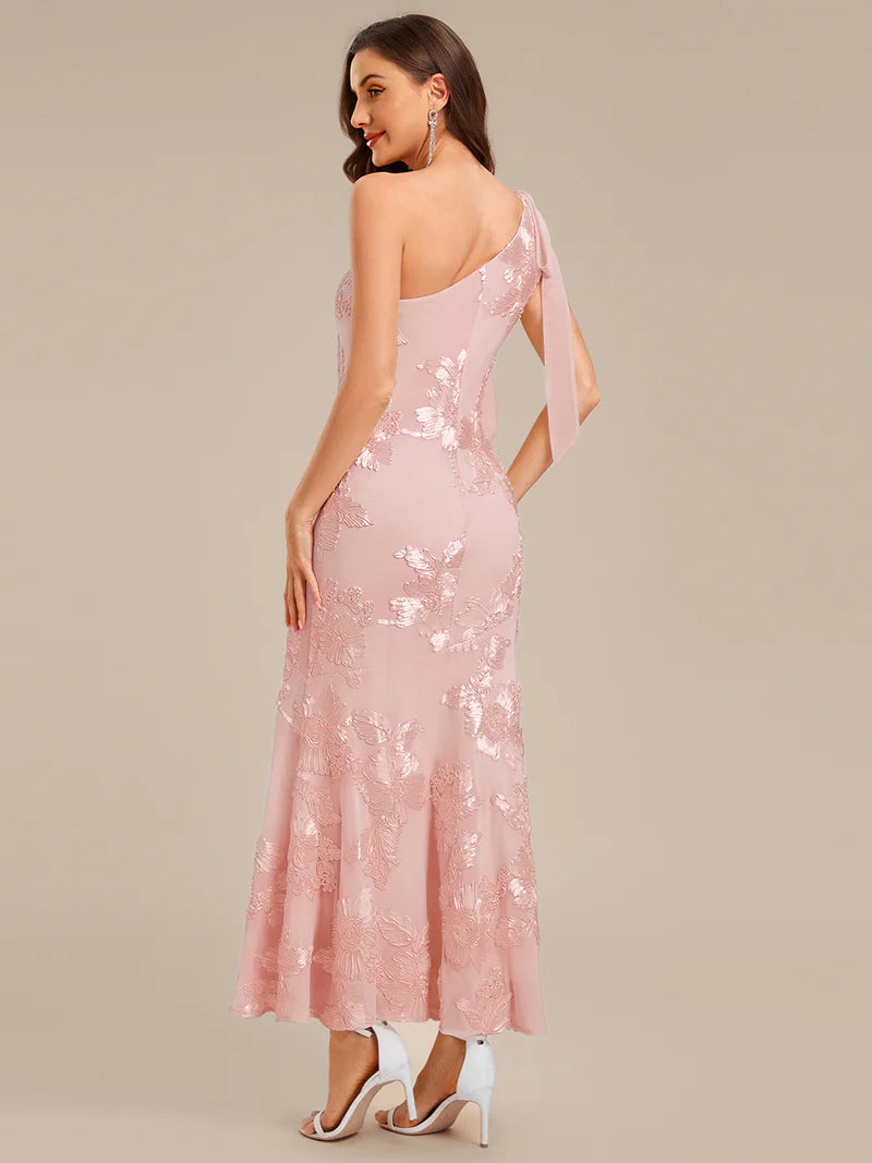 Woman wearing a pink sequin dress on a beige background