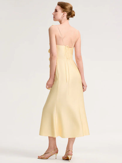 Woman wearing a light yellow dress on a white background
