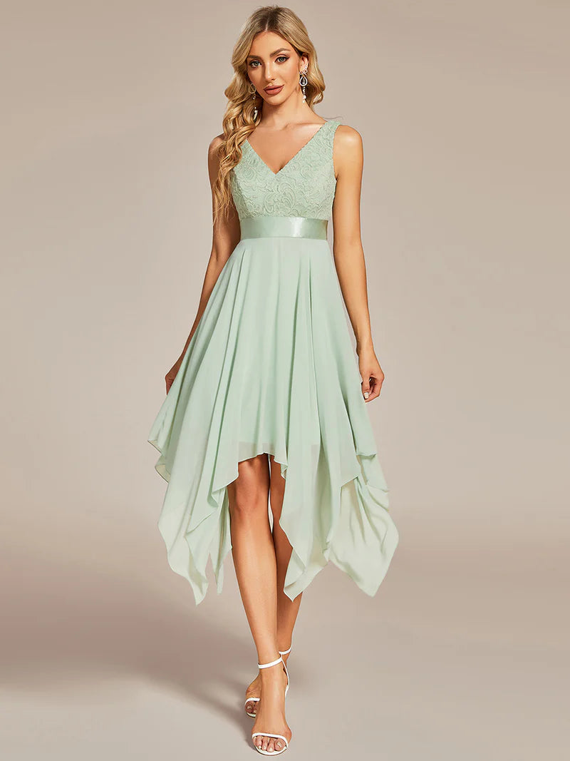 Woman wearing a mint green dress with a plain background
