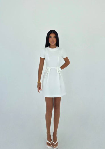 Simple and elegant white mini dress with waist bow details for a casual look